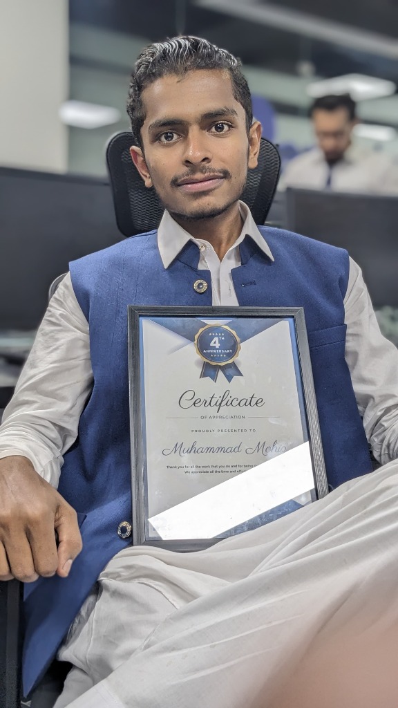 Muhammad Mohiz holding Certificate of Appreciation at 4th Anniversary
